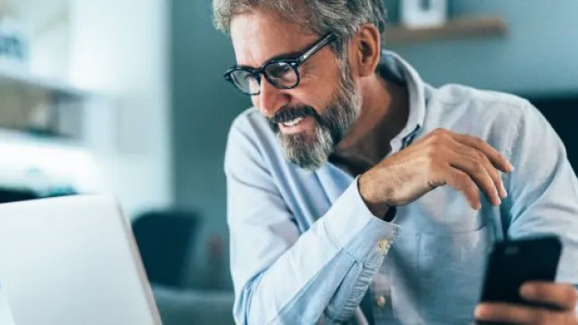 A man looking at his monitor